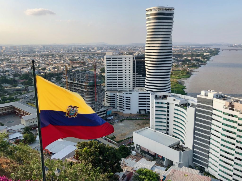 Ecuadorian flag flying in front of Ecuador's tallest building and over top of Guayaquil