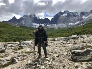 Man trekking in Patagonia with hiking pole and mountain in background